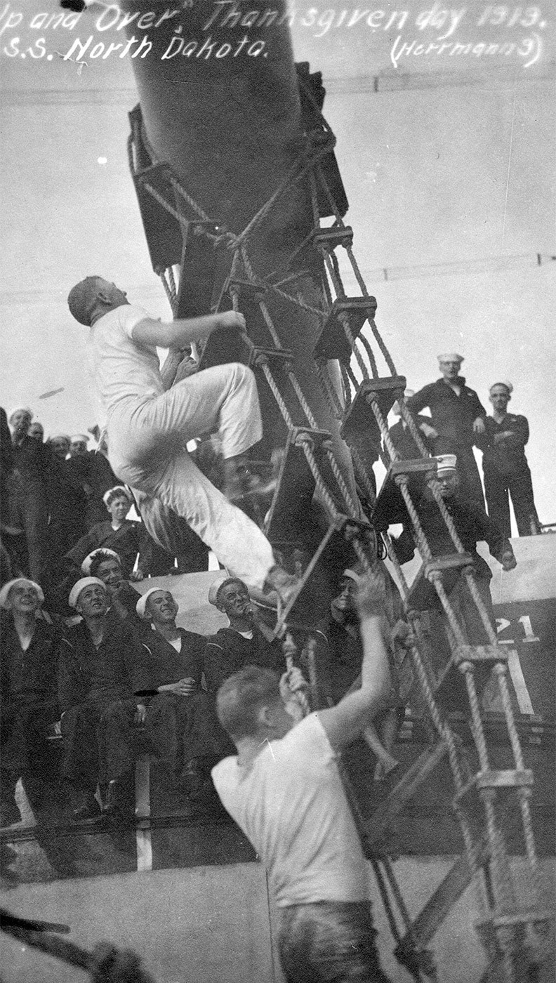 sailors on the battleship USS North Dakota run an obstacle course on Thanksgiving Day 1919