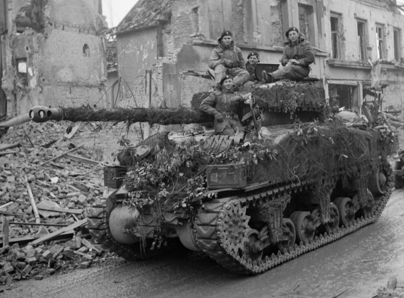 British Sherman Firefly drives through Geldern Germany in March 1945