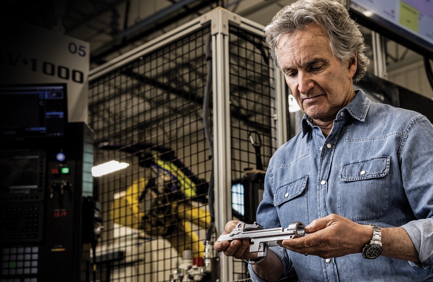 Dennis Reese holding Springfield Armory M1A rifle receiver during the manufacturing process