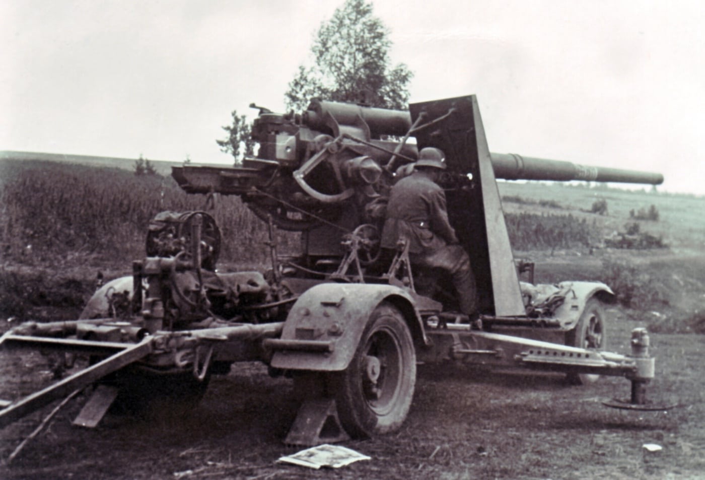 On the Eastern Front, a German soldier is seen manning an 88mm Flak 36 gun, aimed at an unseen target. Originally designed for anti-aircraft defense, the gun’s firepower makes it a formidable anti-tank weapon against Soviet forces. The soldier’s posture and attention to the weapon emphasize its critical role in the intense Eastern Front campaigns. This scene reflects the ingenuity of German tactics and the 88mm’s reputation as a versatile battlefield asset.