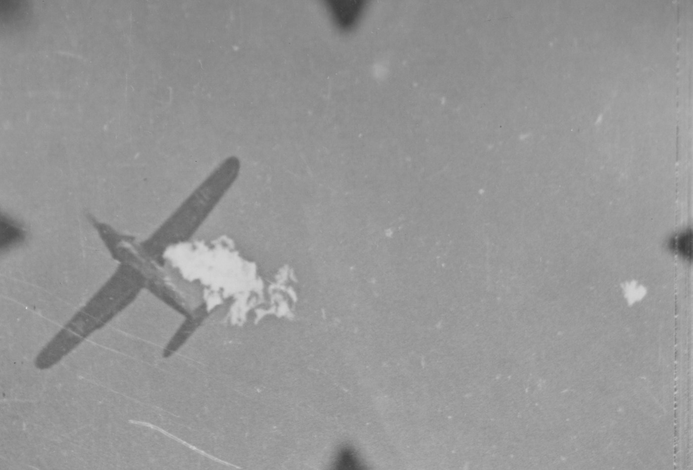 A gun camera on a Republic P-47 Thunderbolt records the decisive moment of an aerial victory against a German Bf 109 fighter. The footage, grainy but clear, showcases the firepower and accuracy of the Thunderbolt in combat. This visual documentation was vital for confirming kills and evaluating pilot performance. The image reflects the intense and dangerous nature of World War II dogfights.