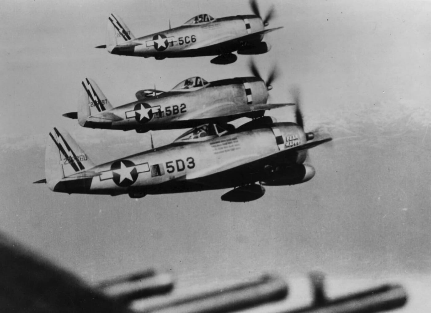 A group of P-47 Thunderbolts flies in tight formation, acting as the ultimate airborne bodyguards for B-25 Mitchell bombers. You can almost hear the roar of engines and the pilots saying, “Not on our watch, Luftwaffe!” Their sleek design and rugged firepower make them look like the Avengers of the sky. Somewhere, a German target is already regretting today’s schedule.