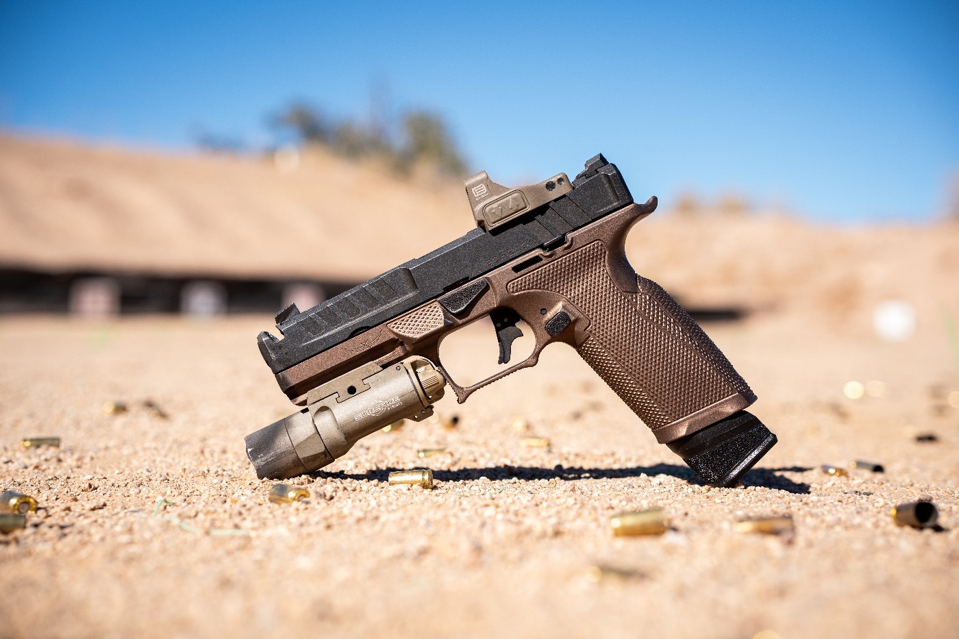 A Springfield Armory Echelon pistol, as used by the author in the training class, is displayed with several custom accessories. The pistol features an A.C.E. grip module by Icarus Precision, constructed from billet 7075 aluminum with aggressive texture and enhanced ergonomics for superior handling. A PRP trigger kit reduces the trigger pull to 3.5 lbs, improving responsiveness. An EOTech EFLX Mini Red Dot is mounted, offering a large, distortion-free field of view for faster target acquisition. This setup showcases the pistol’s optimized performance for speed and accuracy, reflecting the author’s focus on advanced shooting techniques.