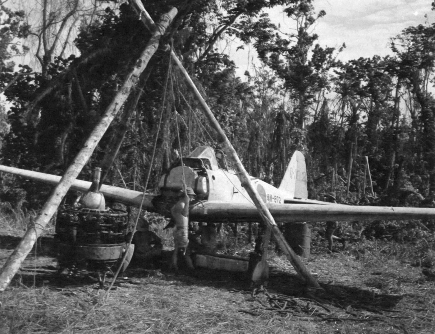 Technical Air Intelligence Unit team works to disassemble an Imperial Japanese Navy fighter plane