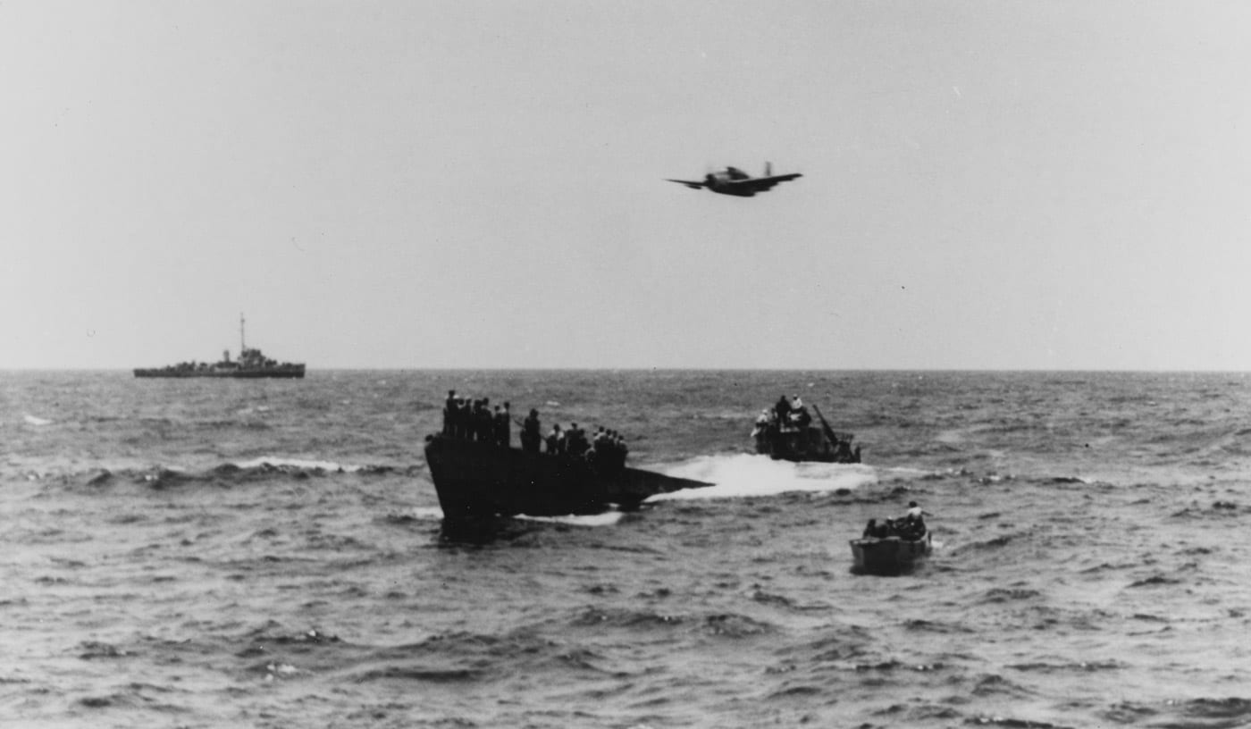 U-505 captured with USS Chatelain in background and a Grumman TBM Avenger flying overhead