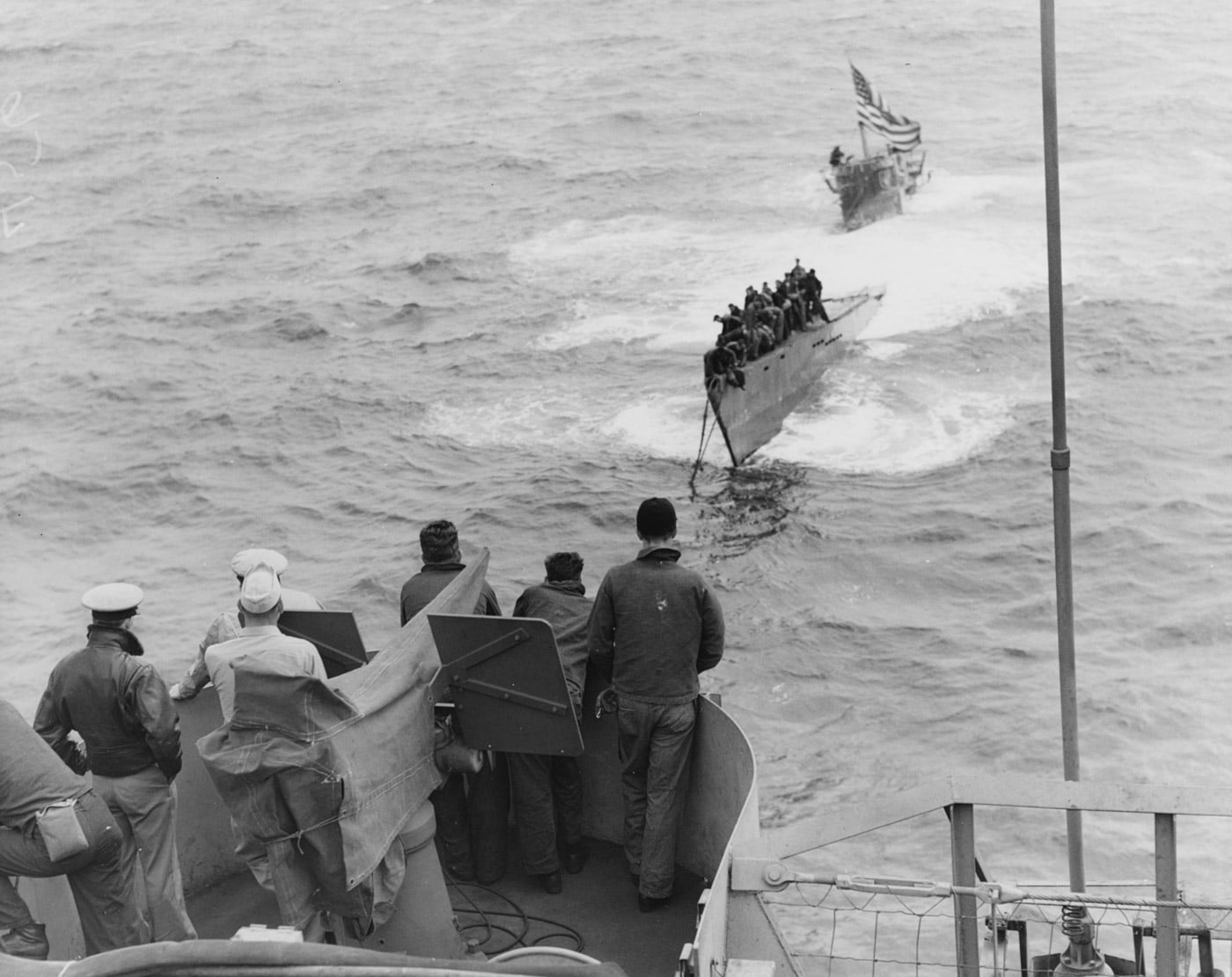 US sailors in 20mm gun tub watch the USS Guadalcanal tow the captured German submarine U-505