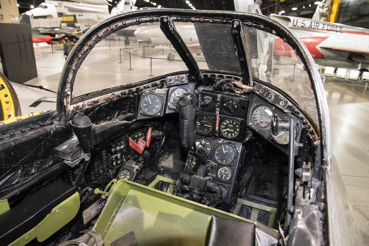 A detailed close-up of the McDonnell XF-85 Goblin’s cockpit shows its compact and streamlined layout. The small space contains essential controls, gauges, and a narrow pilot seat, reflecting its role as a parasite fighter. The design emphasizes simplicity and efficiency due to the limited space available. This image highlights the ingenuity of engineering in the late 1940s aviation industry.