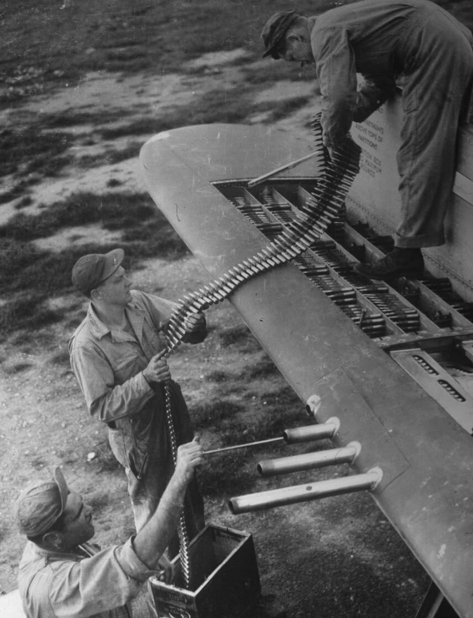 Loading .50 BMG ammo into the wings of a P-47 Thunderbolt looks like the aviation version of packing a lunchbox, except this meal packs a serious punch. The crew’s focus shows they know this is no ordinary chore — it’s prepping for air supremacy. Each bullet is a promise of protection and a message to the enemy: stay out of the sky. This is teamwork at ground level, making sure the Thunderbolt is locked, loaded, and lethal!