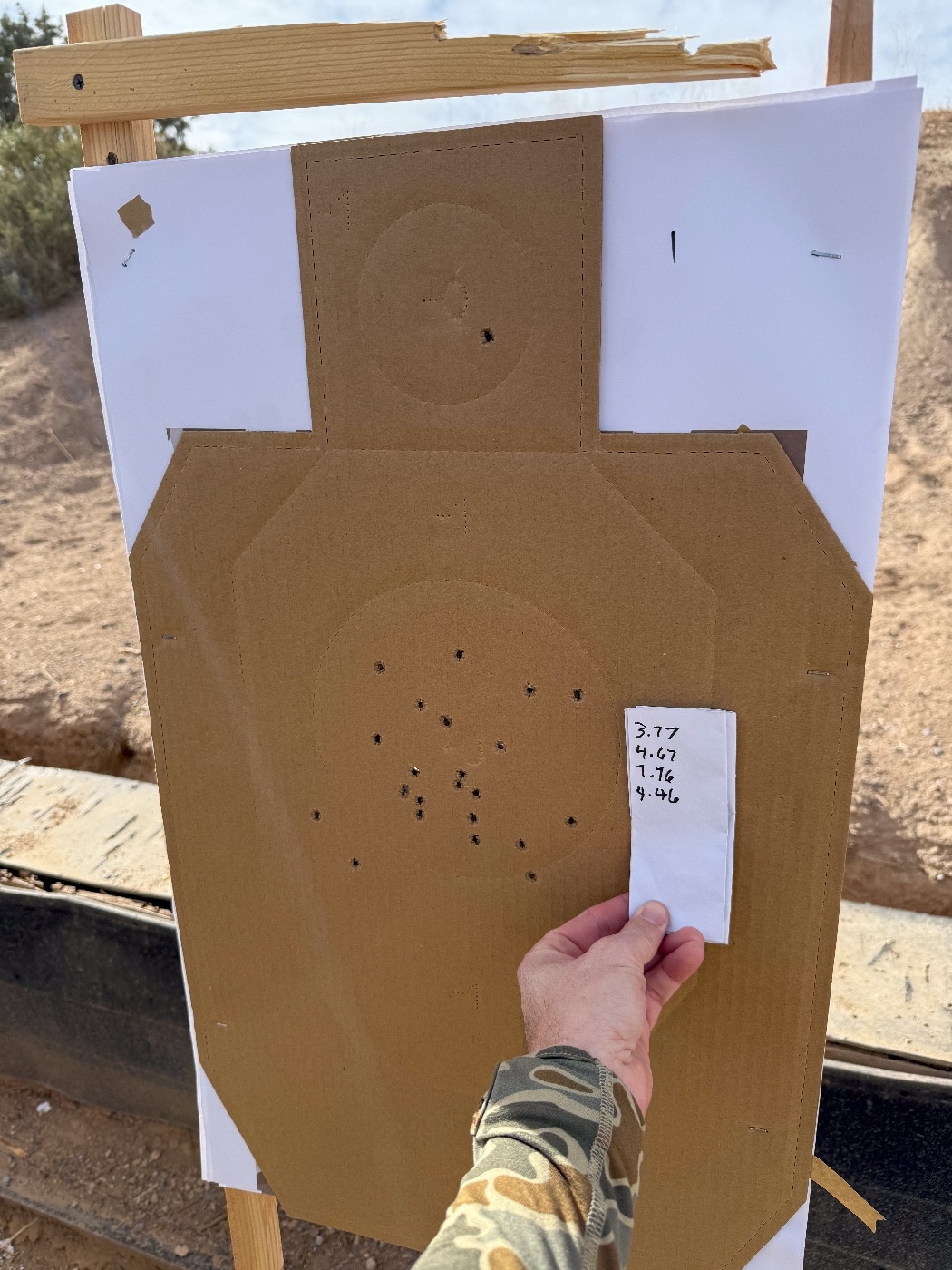 A paper target from the Gunsite Academy range is shown after a day of shooting during the Performance Pistol Symposium. The target features several tightly grouped bullet holes, demonstrating significant improvement in accuracy and consistency. The central scoring zones are heavily marked, reflecting successful hits during drills. This image highlights the effectiveness of the advanced training exercises and the personalized coaching provided by the instructors. The target’s clean design and clear scoring areas emphasize the measurable progress made by participants in speed and precision shooting.