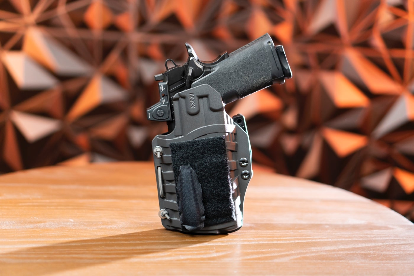 A close-up of the PHLster Wedge system, featuring several wedge shapes and sizes designed to improve comfort and concealment for the Floodlight2 holster. The wedges are attached using a durable hook-and-loop system, allowing users to customize how the holster rides inside the waistband. The modular design lets wearers adjust the angle and depth of the holster for optimal fitment based on body type and carry preferences. The material is soft yet firm, ensuring durability without sacrificing comfort during long wear. These wedges help press the pistol grip closer to the body, enhancing concealability for appendix and other carry positions. The photo emphasizes the adaptability and ease of use of the system, suitable for concealed carry enthusiasts seeking personalized solutions. The variety of shapes highlights the flexibility of the PHLster holster system.