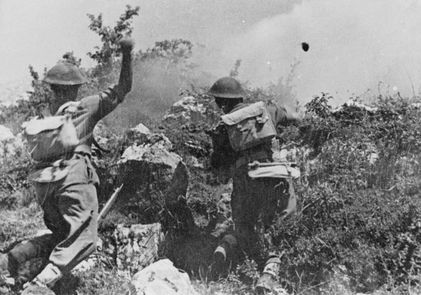 Polish soldiers of the 2nd Polish Corps assault German positions during the Battle of Monte Cassino, using grenades and rifle fire to advance under heavy resistance. The intense combat takes place amidst rugged terrain, with debris and rocky outcroppings providing cover for both sides. This action was part of the Allied effort to breach the Gustav Line and capture the strategically vital monastery atop Monte Cassino Hill. The image captures the determination and bravery of Polish troops, who played a pivotal role in the eventual Allied victory. It highlights the fierce and close-quarters nature of the fighting that defined this critical phase of the Italian Campaign.