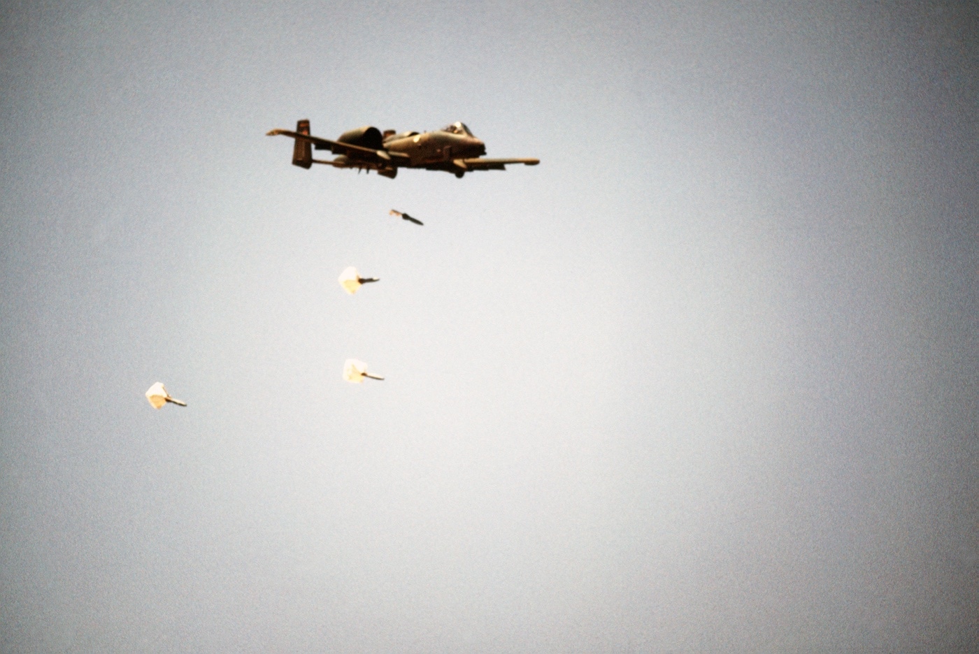 Republic A-10 Thunderbolt II dropping parachute retarded bombs in training exercise