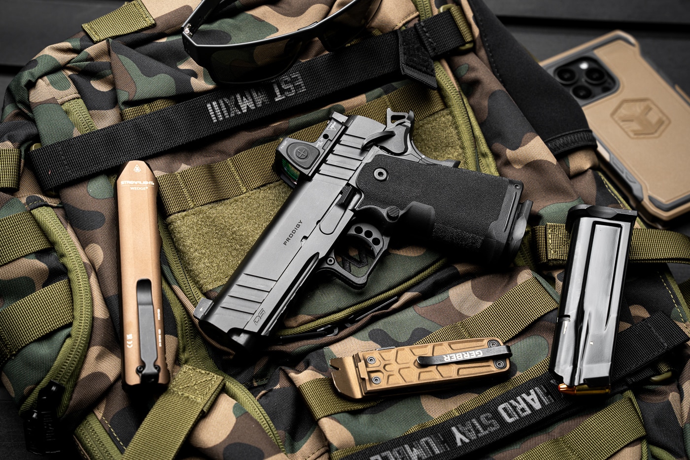 The Springfield Armory 1911 DS Prodigy Compact with a 4.25-inch barrel is shown, highlighting its features tailored for concealed carry. The compact grip and slim profile ensure it remains discreet under clothing, while its 15+1 round capacity delivers ample firepower. The image captures its refined design, with a Cerakoted slide for durability and a tritium front sight for low-light aiming. This pistol combines reliability, safety, and ease of carry for everyday defensive use.