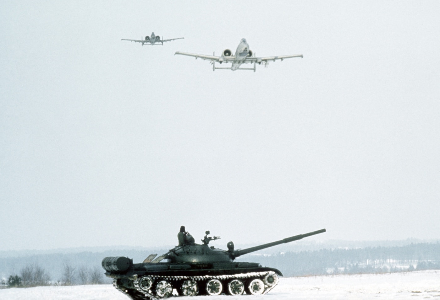 at the end of the Cold War US A-10 attack planes fly over Soviet T-62A tanks