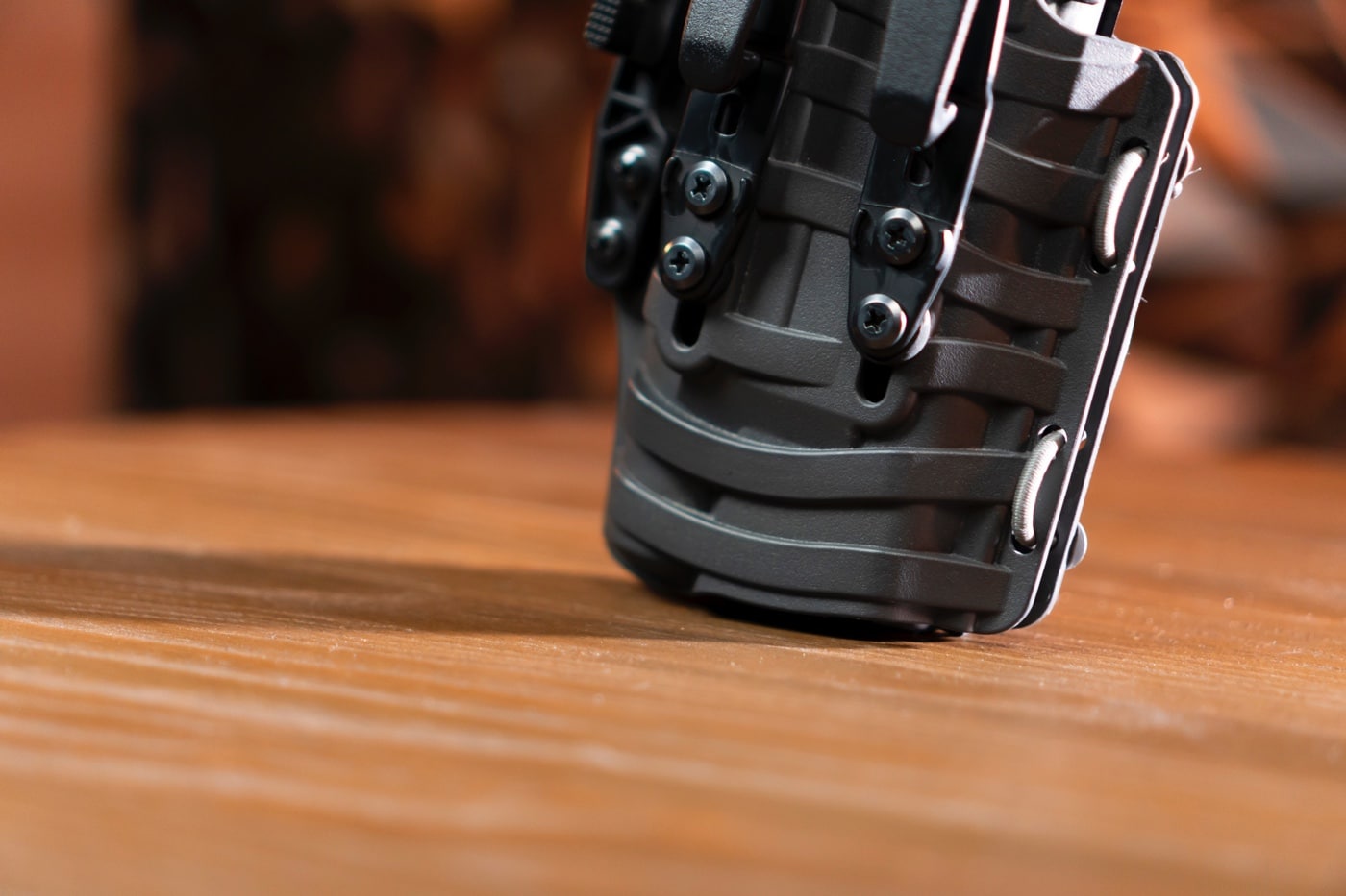 A close-up view of the ComfortScape texture on the PHLster Floodlight2 holster, highlighting its wave-like grooves designed to improve airflow and comfort. The unique pattern creates small ventilation channels that reduce heat buildup and prevent discomfort during extended wear. This feature ensures the holster feels smooth against the skin, even in warm conditions or under active movement. Made from durable Kydex, the holster combines rigidity with ergonomic design for concealed carry. The grooves are an innovative addition that sets the Floodlight2 apart from traditional holsters. This texture not only improves comfort but also adds a sleek aesthetic to the holster. Ideal for inside-the-waistband carry, the ComfortScape demonstrates PHLster's commitment to user-focused innovation.