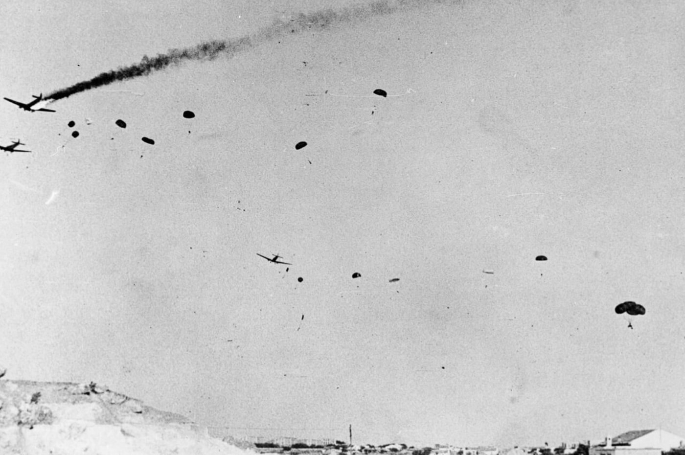 paratroopers jump from Ju 52 struck by AA fire during Battle of Crete