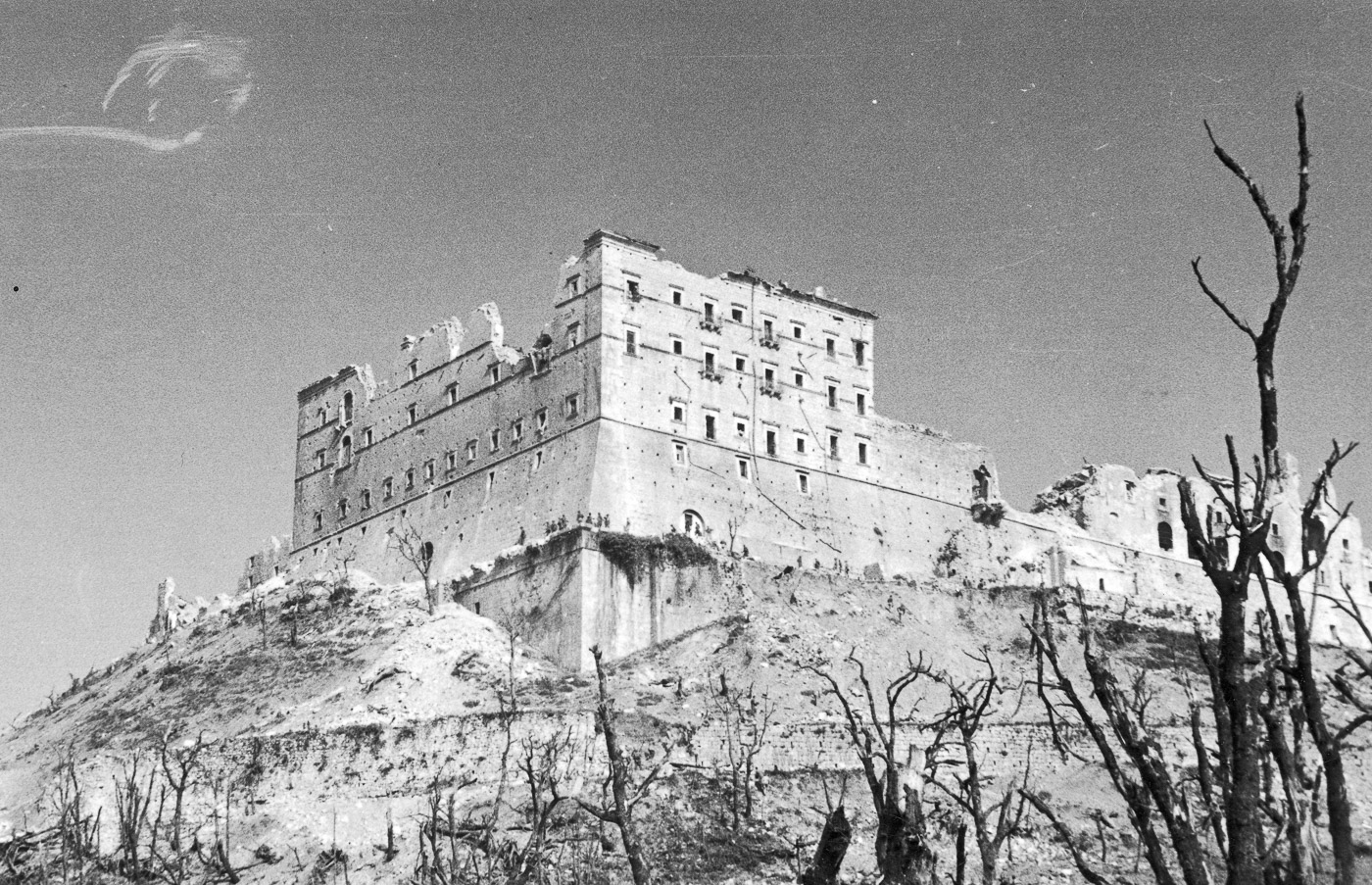 The ruins of the Monte Cassino monastery stand as a stark reminder of the intense fighting during the Battle of Monte Cassino in 1944. Once a historic and sacred site, the monastery lies in complete devastation, with crumbled walls and scattered debris dominating the landscape. This destruction resulted from heavy Allied bombing and prolonged combat as part of the effort to break through the German-held Gustav Line. The image reflects the immense toll of war on cultural and historical landmarks during the Italian Campaign. Despite the destruction, the monastery’s ruins became a symbol of resilience and the Allied commitment to advancing in the face of fierce German resistance. The scene is both haunting and emblematic of the high cost of the prolonged battle.