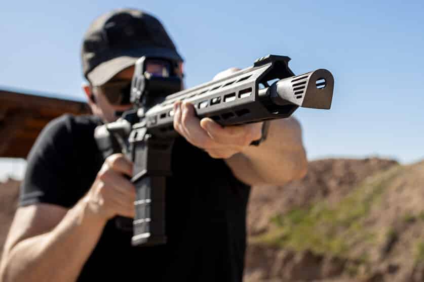 Author firing the Springfield Armory SAINT to evaluate the Walker NERO 762’s performance. The advanced muzzle brake delivers impressive stability and precision. shooting AR10 rifle with Walker NERO 762 Inconel muzzle brake attached