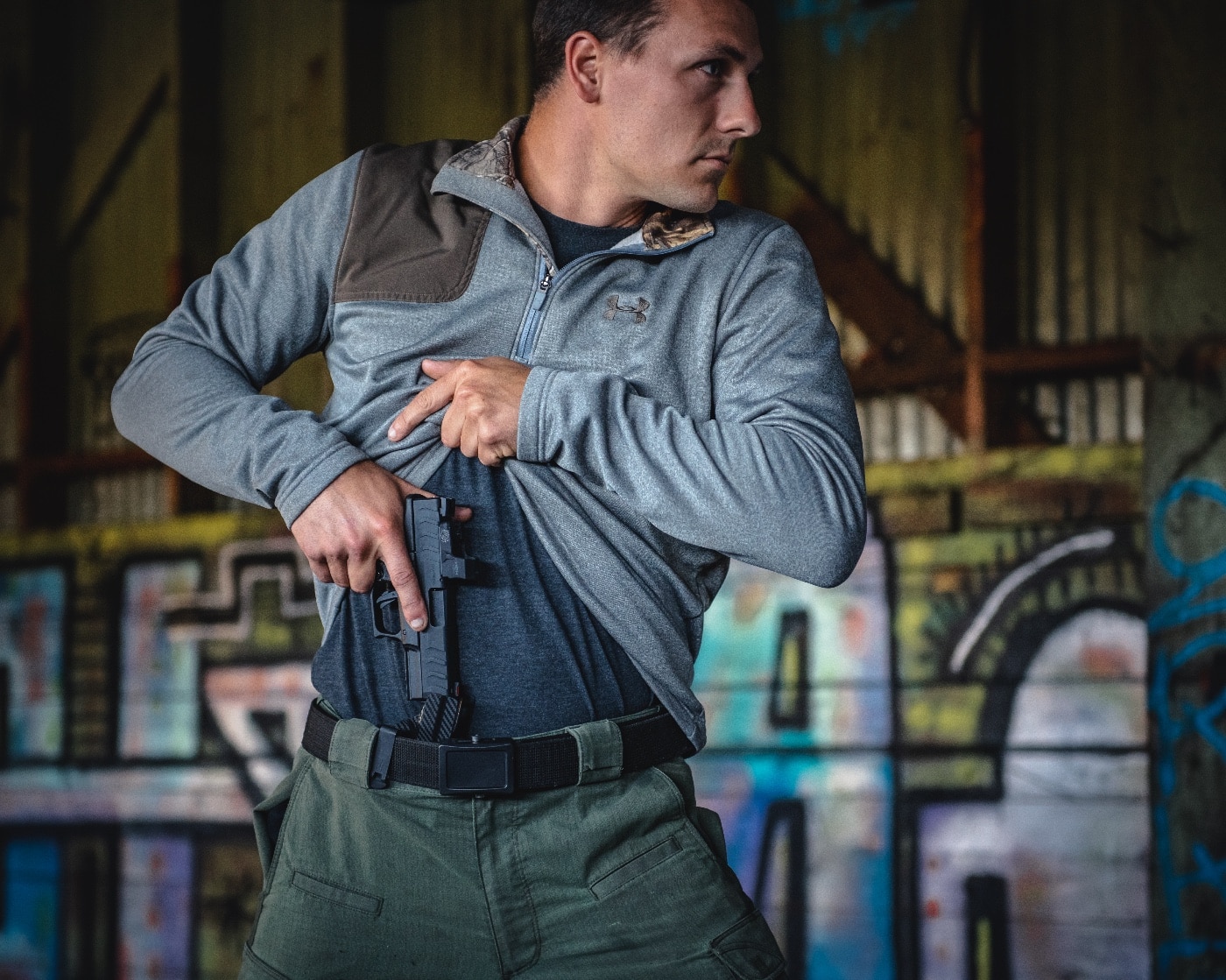 A man performs a rapid draw from an appendix inside-the-waistband (AIWB) holster during a self-defense training exercise. His hands move efficiently, lifting his shirt and gripping the firearm as he prepares to respond to a simulated threat. Defensive firearm training emphasizes the importance of legal concepts such as reasonable fear, imminent peril, and justified use of force. In self-defense cases, courts consider whether the individual had a reasonable belief that lethal force was necessary to prevent bodily harm. Stand Your Ground and Castle Doctrine laws vary by jurisdiction, affecting whether a person has a duty to retreat before using force. Many legal defenses in self-defense cases rely on principles such as burden of proof, affirmative defense, and totality of the circumstances. Training ensures gun owners understand their rights, the laws governing concealed carry, and the legal implications of using deadly force. Criminal defense attorneys and prosecutors analyze self-defense claims based on factors such as evidence, witness testimony, and applicable statutes. Mastering safe and effective firearm handling techniques through structured training enhances personal safety and legal preparedness.