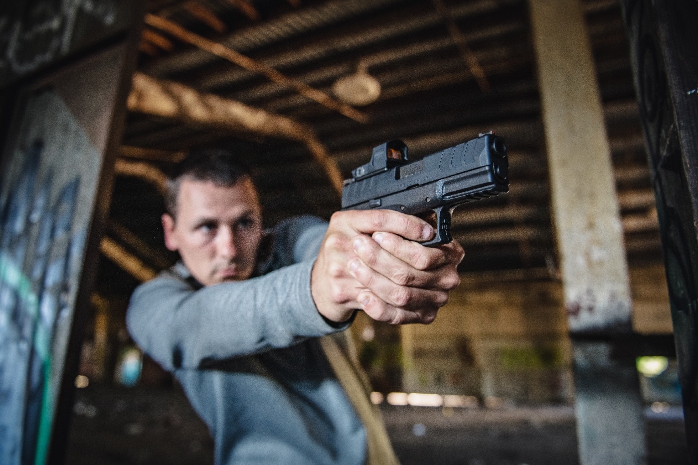 A man leans out from behind cover, gripping his firearm tightly as he prepares to engage a deadly threat during a self-defense training exercise. His posture is tense and focused, using the available cover to protect himself while maintaining a clear line of sight on the simulated attacker. Defensive training reinforces the importance of using reasonable force, assessing imminent danger, and understanding self-defense laws. The Castle Doctrine and Stand Your Ground laws vary by state, determining whether a person has a legal duty to retreat before using lethal force. In self-defense cases, courts examine whether the individual had a reasonable belief that their life was in danger. Prosecutors, defense attorneys, and juries analyze factors such as immediate threat, provocation, and proportionality when determining legal justification. Tactical positioning behind cover can affect how legal cases are assessed, especially in determining whether a person had an opportunity to retreat. Legal principles such as affirmative defense, burden of proof, and justifiable homicide play a significant role in determining whether self-defense claims hold up in court. Proper training helps individuals prepare for both real-world encounters and legal scrutiny following a defensive shooting.