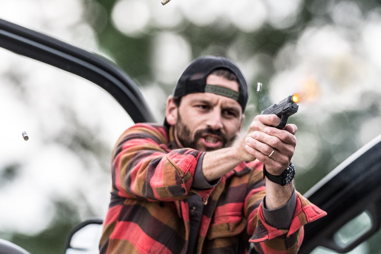 A man grips his firearm with both hands, raising it to eye level as he participates in a deadly force training scenario. His expression is serious and focused, reinforcing the importance of using a firearm only when absolutely necessary. Defensive training exercises like this one teach individuals how to assess threats, use situational awareness, and understand self-defense laws. In many jurisdictions, self-defense laws, including Stand Your Ground and Castle Doctrine, allow individuals to use lethal force when facing imminent danger. The legal principle of reasonable fear is often debated in courtrooms, with prosecutors, defense lawyers, and juries weighing whether force was justified. Courts consider key factors such as the totality of the circumstances, duty to retreat, and whether the defendant had a reasonable belief that they were in danger. In cases involving self-defense, the burden of proof may shift to the defendant to demonstrate that their actions met legal standards. Stand Your Ground laws remove the requirement to retreat before using defensive force, while other jurisdictions mandate de-escalation before engaging in deadly force. Proper training helps ensure that gun owners act responsibly, both in terms of firearm handling and legal knowledge.