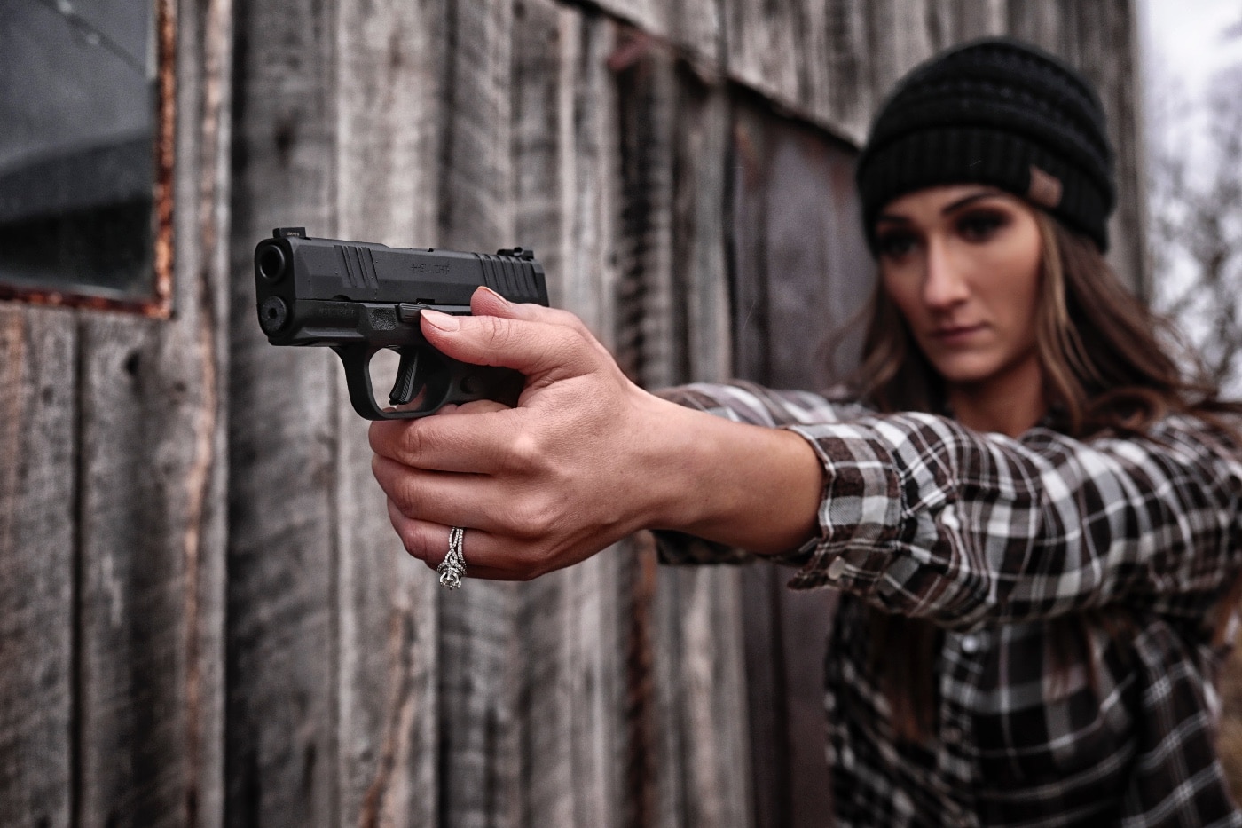 A woman holds a pistol with both hands, aiming at a designated target during a defensive shooting training exercise. Her stance is balanced, and her expression is serious as she prepares to respond to a simulated deadly threat. Defensive firearm training teaches essential skills such as proper grip, sight alignment, and trigger control while reinforcing legal principles like self-defense, reasonable fear, and justified use of force. Many jurisdictions recognize Castle Doctrine and Stand Your Ground laws, which provide legal protection for individuals facing imminent danger. The legal burden often falls on the person using force to prove that their actions were necessary and lawful. Prosecutors and defense attorneys examine self-defense claims based on evidence, witness testimony, and the totality of the circumstances. In some states, jurors must decide whether the use of force was proportional to the perceived threat. Understanding legal topics such as affirmative defense, criminal charges, and civil liability is crucial for responsible gun owners. Defensive training ensures individuals are prepared to make legally sound decisions when facing a violent crime or home invasion.