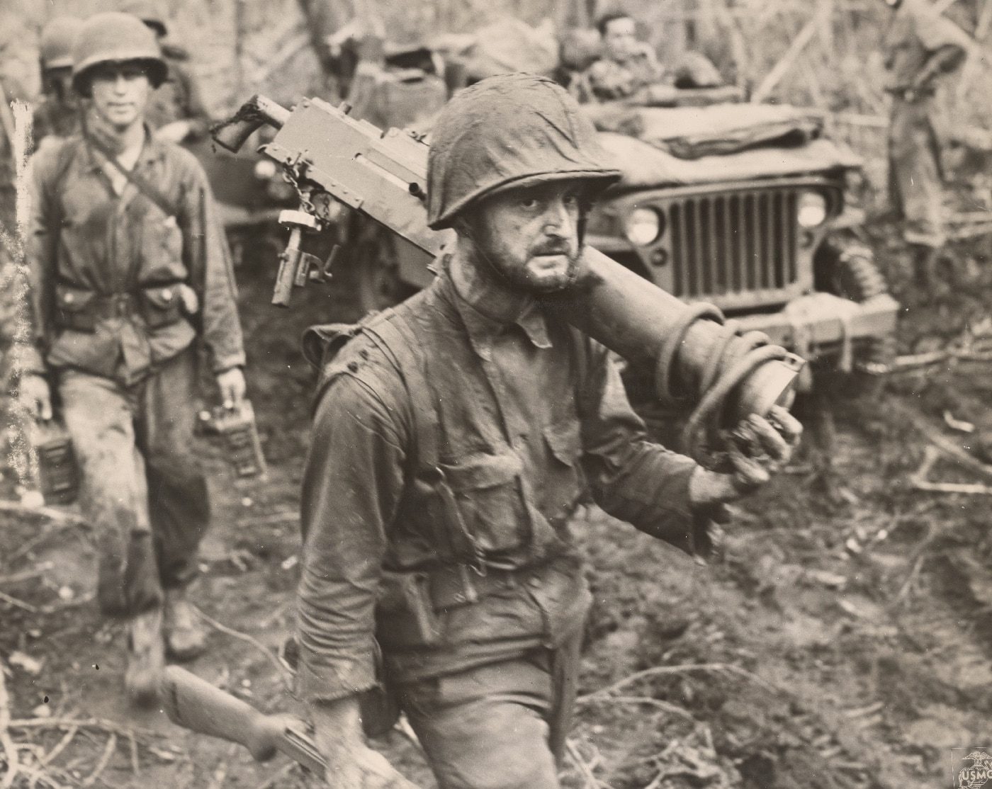 Pfc George C Miller carries a machine gun on Cape Gloucester