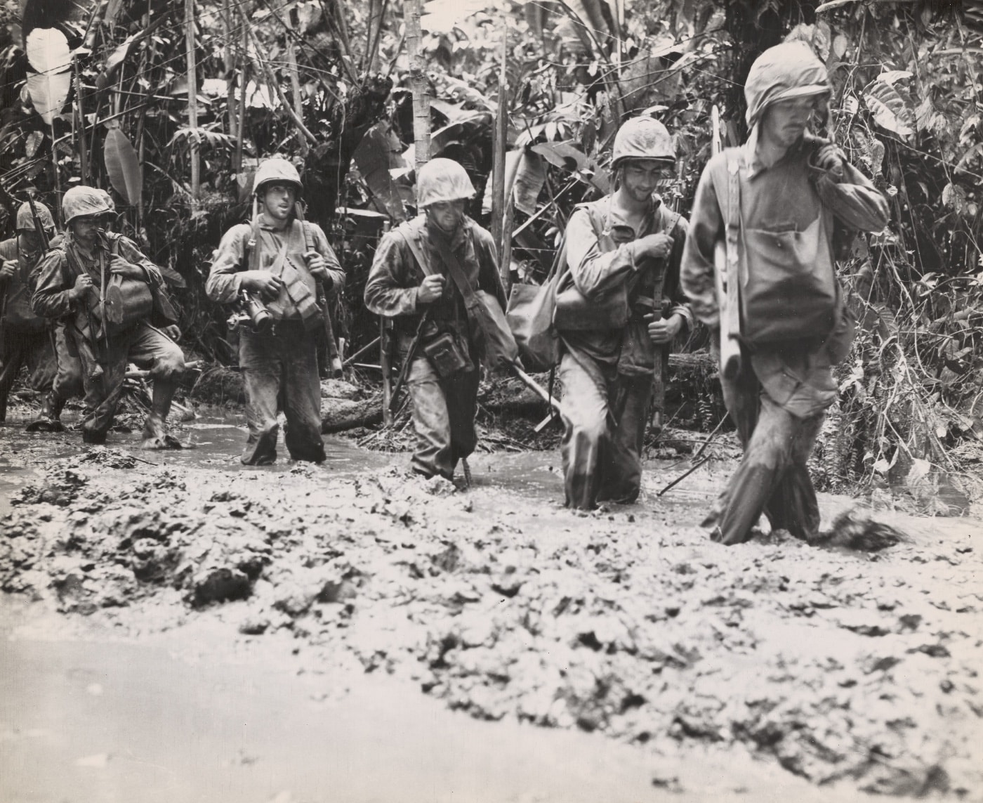 US Marines move through deep thick mud