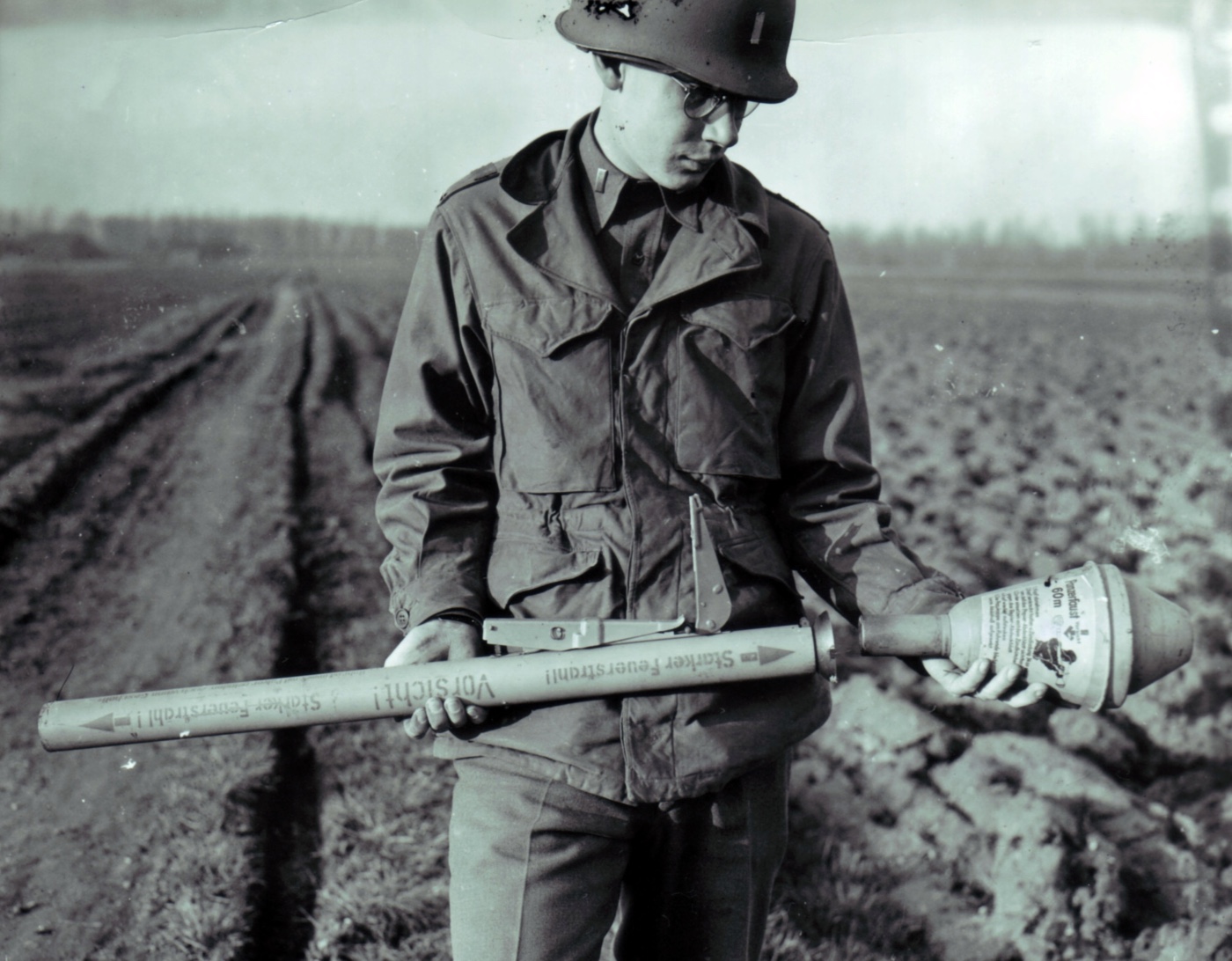 lieutenant in United States Army examines a captured Panzerfaust 60