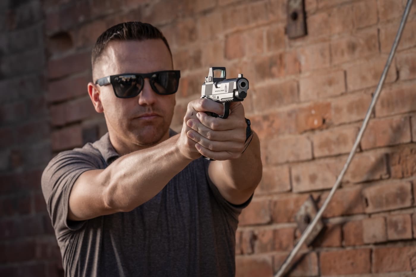 man aiming Springfield Armory 1911 in self defense EDC