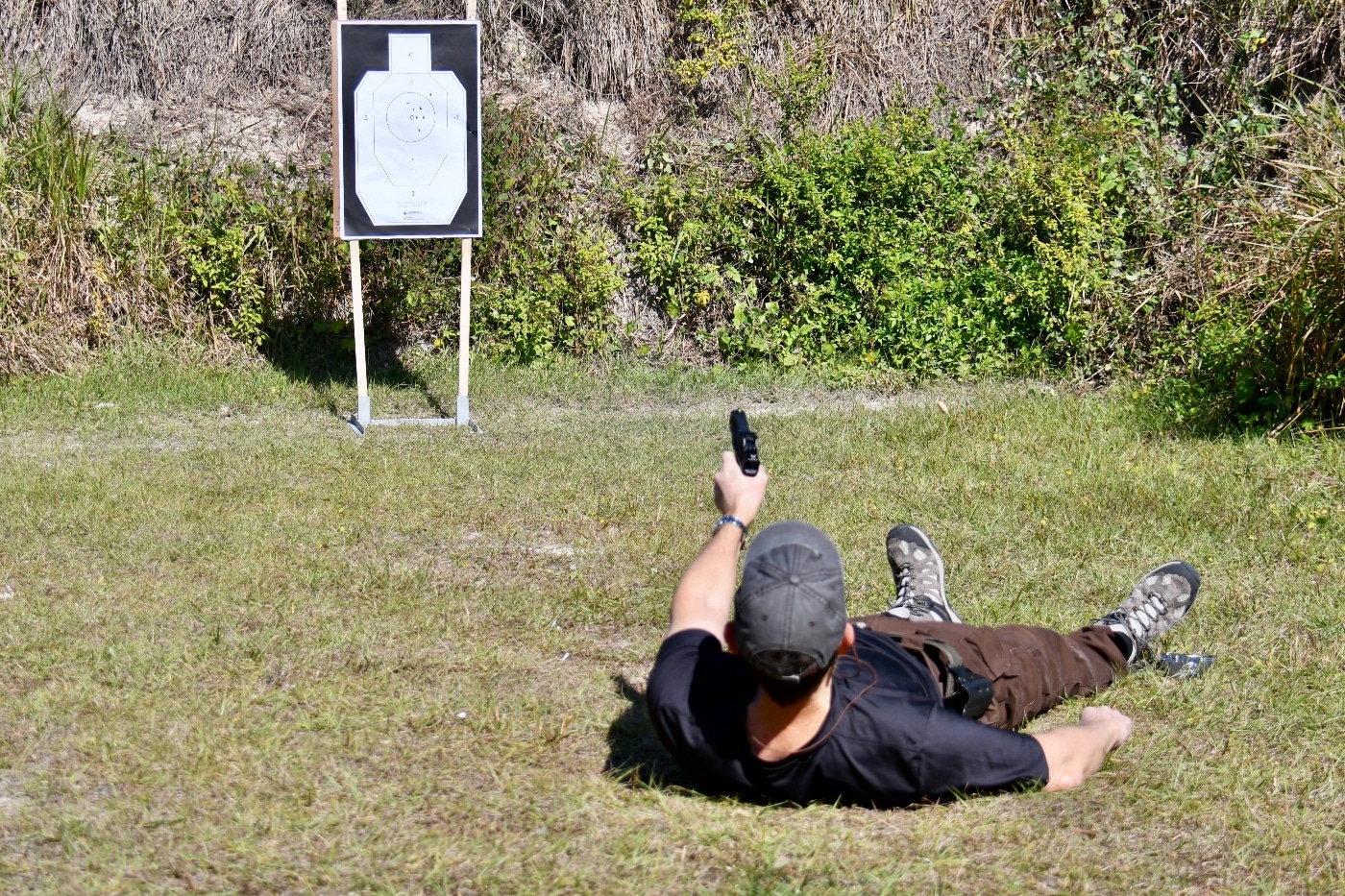 shooting defensive pistol from your back on the shooting range during firearms training