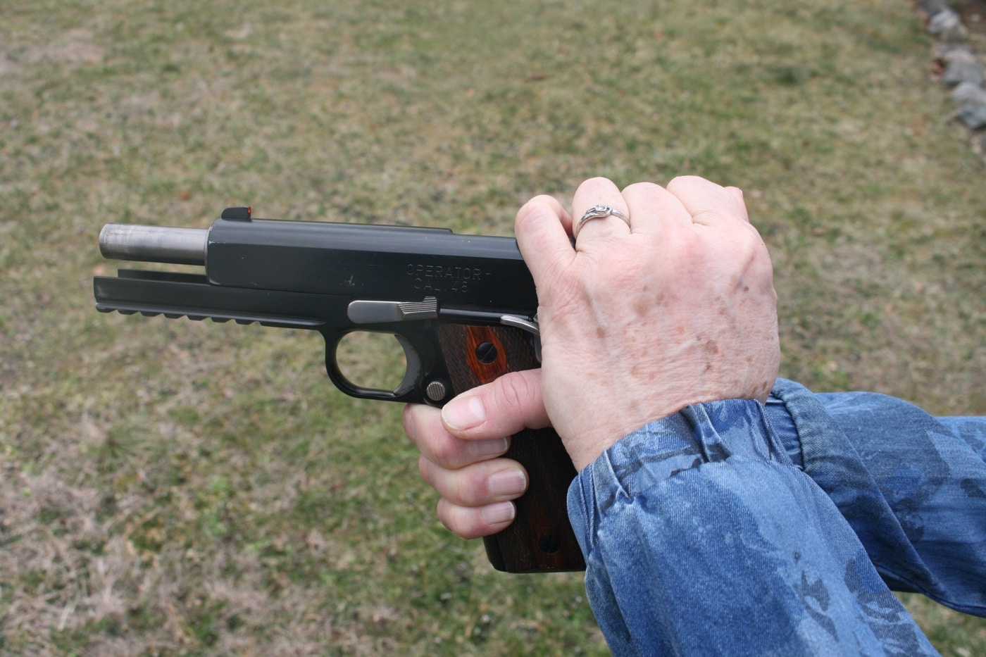 This photograph shows a senior citizen pulling back the slide of his 1911 pistol, highlighting the importance of hand strength for effective shooting skills. It illustrates how older adults maintain precision and control during target shooting and self defense. The image emphasizes active shooter training and the adaptation of techniques to overcome challenges such as arthritis and reduced motor skills. The subject's determined expression underscores the need for regular physical conditioning to improve grip safety and trigger control. This demonstration reflects a commitment to safe action and proper firearm handling at the shooting range. Overall, the scene inspires resilience and focus in defensive shooting skills for senior citizens.