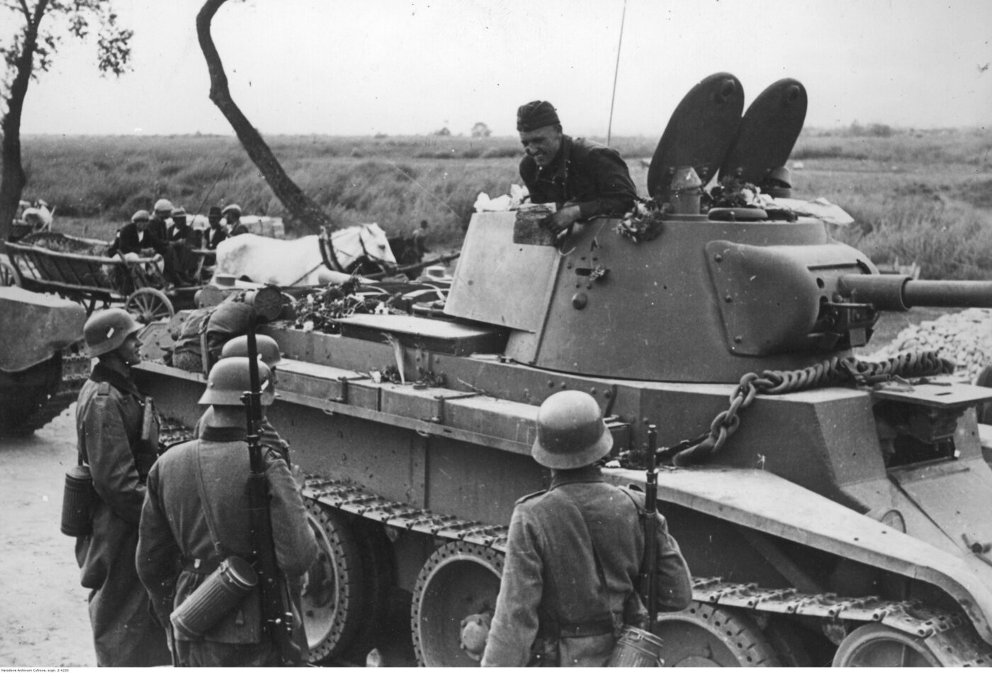 Soviet troops in BT-7 tanks meet their German allies in Poland.