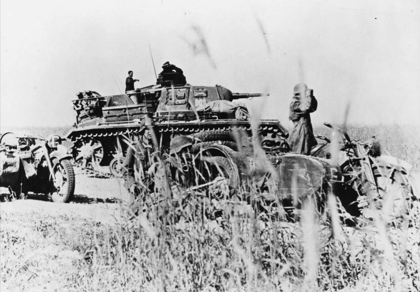 This image shows a Panzer III command tank, also known as Panzerkampfwagen III, positioned prominently with its detailed turret and main armament as it leads General Guderian’s 2nd Panzer Group during Operation Barbarossa in the summer of 1941. Motorcycles accompanying the tank emphasize the rapid, mechanized mobility characteristic of blitzkrieg tactics employed by the Army Group Centre. The scene vividly portrays the evolution of German armored forces and mechanized troops within the Wehrmacht, highlighting the engineering prowess behind these panzers crafted by Rheinmetall. The composition captures a moment of decisive action on the Eastern Front, echoing the strategic innovations that defined armored warfare in World War II. The interplay between the command tank and its supporting motorcycles reflects the dynamic coordination of panzer divisions in early Nazi Germany military campaigns.