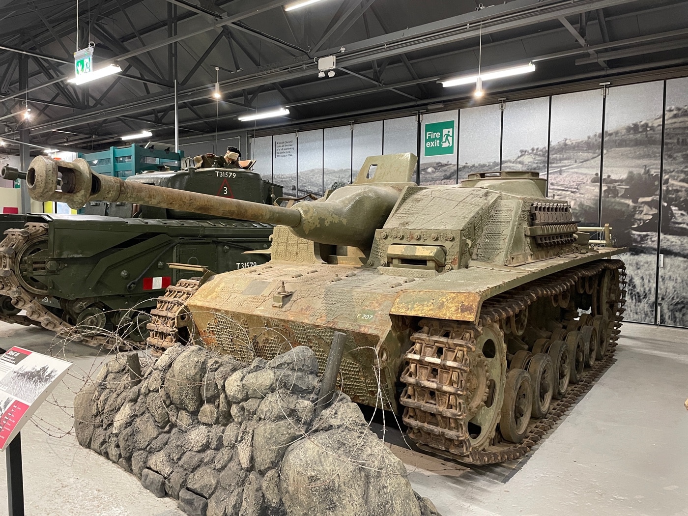 This image shows a StuG III assault gun, built on the robust Panzer III chassis, on display at the Bovington Tank Museum in England. The turretless design highlights its evolution from the classic Panzerkampfwagen III, a key asset of German armored forces during World War II. The vehicle's exposed chassis and distinctive armor plates reflect engineering innovations pioneered by Rheinmetall and utilized by panzer divisions and mechanized troops. Its design underscores the shift from traditional tank roles to specialized assault guns used in blitzkrieg tactics during battles such as Kursk and Stalingrad. This historic armored fighting vehicle serves as a vivid reminder of Nazi Germany’s contributions to modern armored warfare.