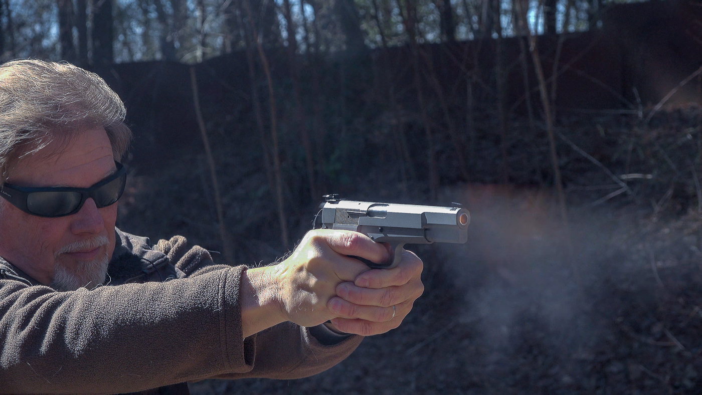 author firing SA-35 on shooting range