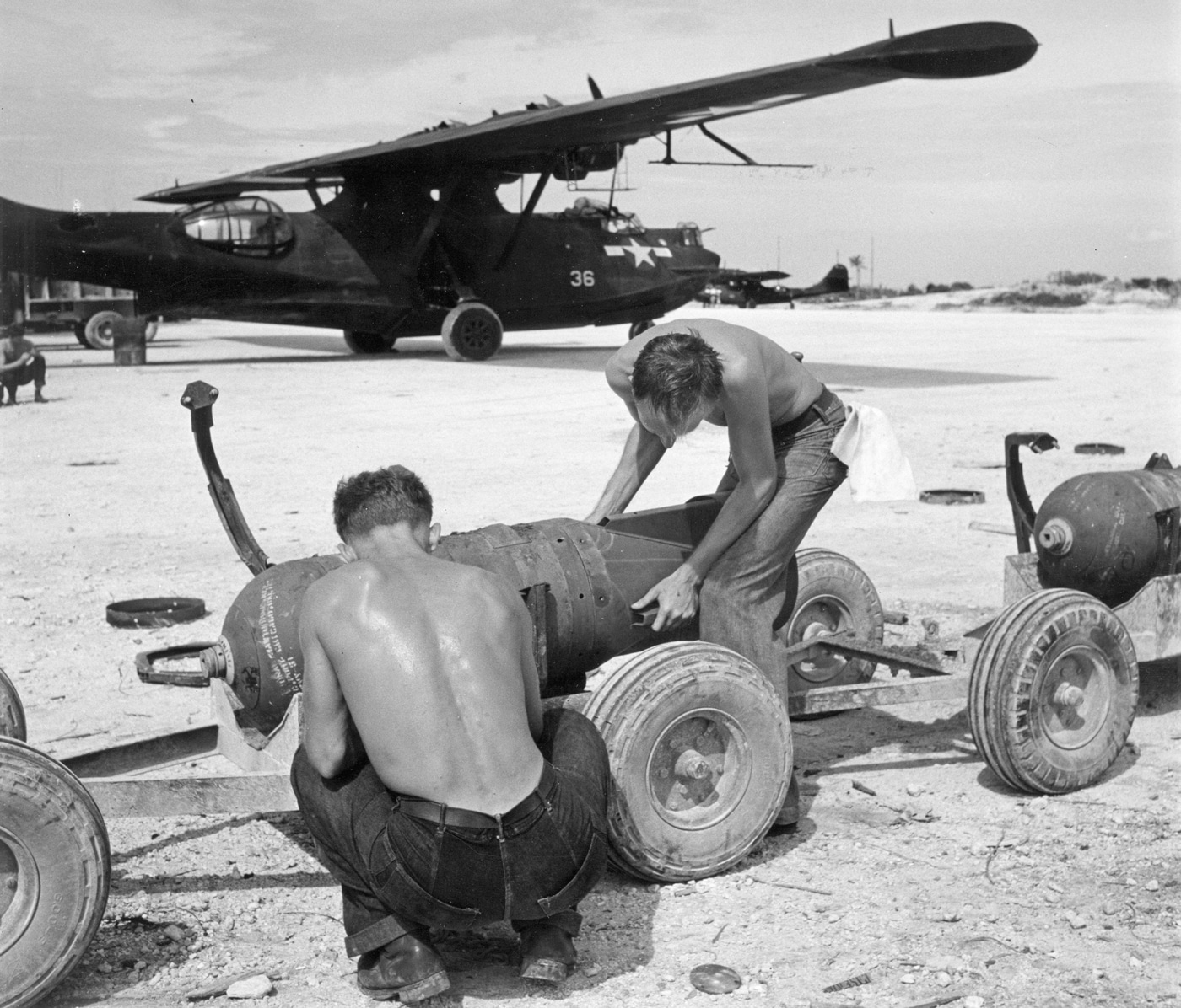 sailors load bombs on PBY Black Cat bombers